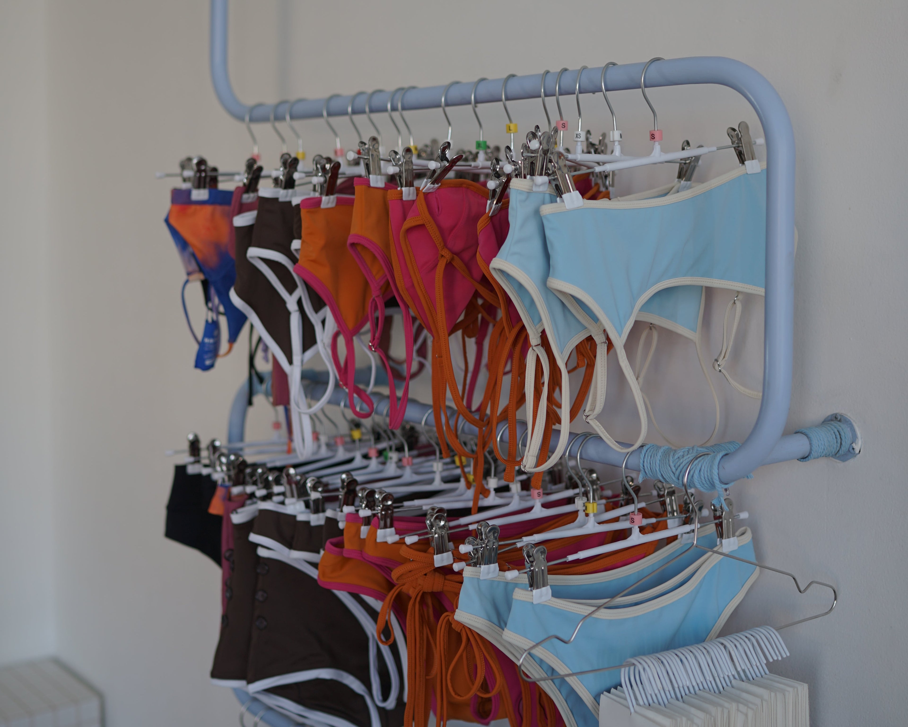 Colorful fabric samples on a rack with a white background